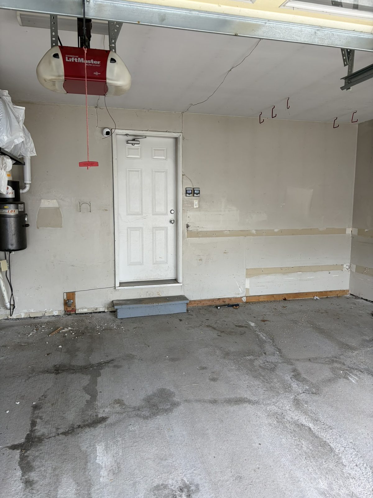 Garage before: cracked, stained concrete floor and bare walls